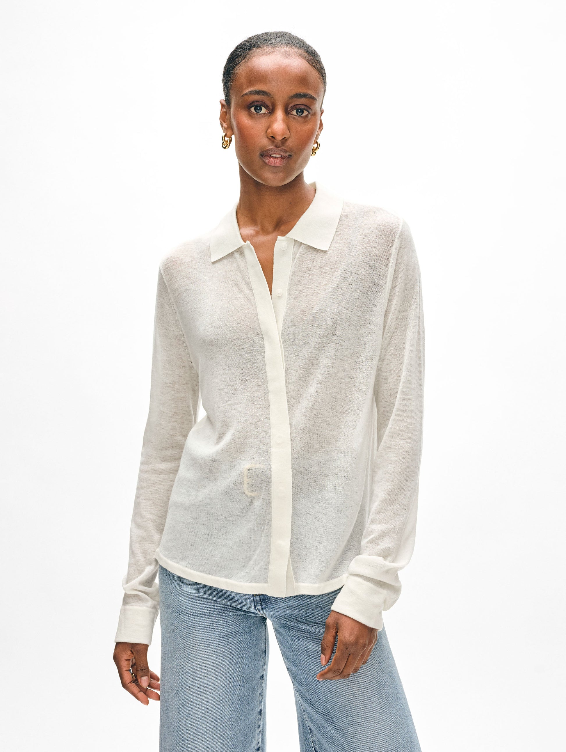 Model wearing white superfine cashmere button down.